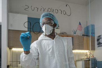 Fototapeta premium Doctor wearing protective workwear writing his precautions to fight Coronavirus