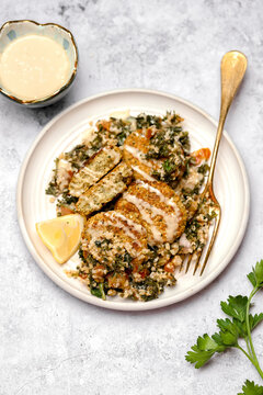 baked chickpea patties over tabouli salad with tahini
