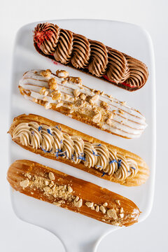 Set of french eclairs. Chocolate, salted caramel, vanilla and earl grey eclairs.