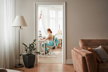 Girl writing at the notebook while studying