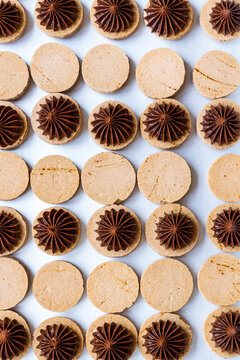 Filling french macarons with dark chocolate ganache.