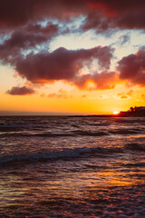 Sea wave with foam under beautiful sunset