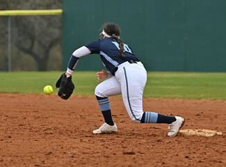 Girls in action playing in a softball game