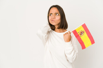 Young hispanic mixed race woman holding a spanish flag touching back of head, thinking and making a choice.