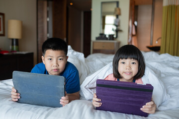 Fototapeta premium two children addicted tablet, asian kid watching cartoon