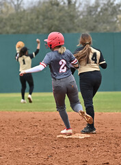 Girls in action playing in a softball game