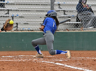 Obraz premium Girl with very long brown hair playing softball in a game
