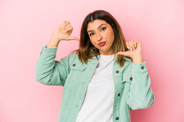 Young indian woman isolated on pink background feels proud and self confident, example to follow.