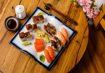 Sashimi and Nigiri sushi set on wooden table