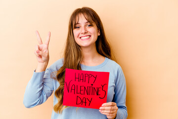 Fototapeta na wymiar Young caucasian woman holding a Happy Valentines day isolated showing number two with fingers.