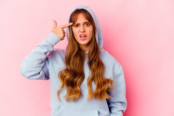 Young caucasian woman with hood isolated on yellow background showing a disappointment gesture with forefinger.