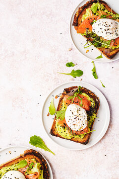 3 smoked salmon toasts with avocado cream, poached eggs and sesam seeds on top, with space for text.