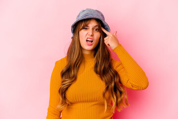 Young caucasian woman wearing fishermans hat isolated showing a disappointment gesture with forefinger.