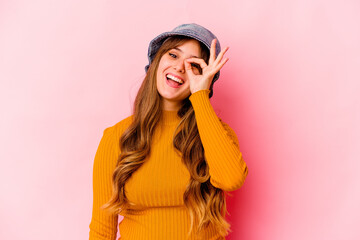 Young caucasian woman wearing fishermans hat isolated excited keeping ok gesture on eye.