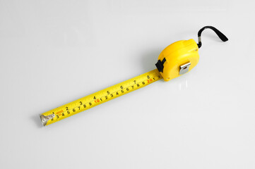 Measuring tape scale yellow roll construction tool inch centimeters size isolated on white background meter equipament work precise