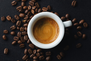Steaming espresso served in cup on dark