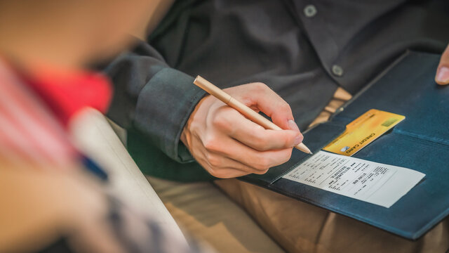 Credit Card Payment Bill And Slip With Hand Holding Pen Ready To Sign To Make Payment