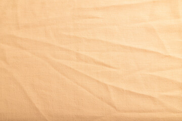Fototapeta na wymiar Fragment of smooth orange linen tissue. Top view, natural textile background.