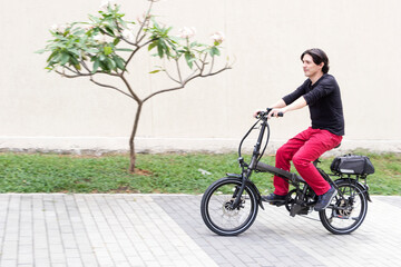 Man on electric bicycle going up hill in medellin