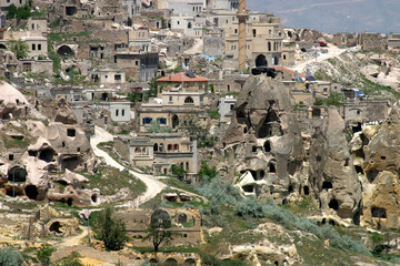 Special stone formation and houses near the Uchisar Castle in Cappadocia, Nevsehir, Turkey. Cappadocia is part of the UNESCO World Heritage Site.