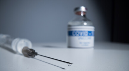 Syringe with Covid-19 vaccine - close up view macro shot
