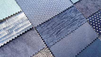 close up catalog of interior luxury fabric sample chart showing multi texture and pattern of fabric in blue and navy color tone. interior drapery and curtain samples palette.