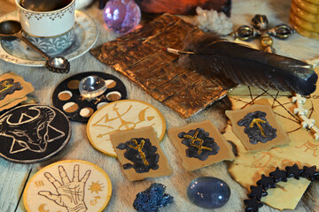Runes, sacred symbols, crystals and magic ritual objects on witch table.