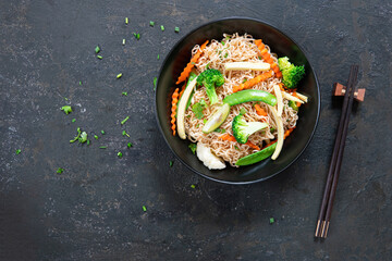 Vegetarian Noodles Thai vegetarian vegetables noodles in a dark background, top view. Vegetarian food in asian style. Copy space