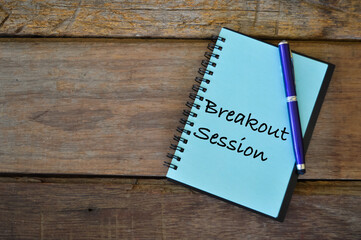 Notebook written with text BREAKOUT SESSION over wooden background. - obrazy, fototapety, plakaty