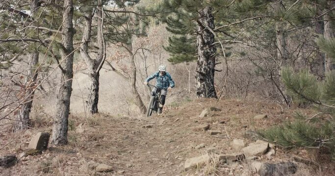 Mountain biker Enduro mtb bike cyclist jump path trail in slow motion