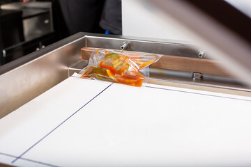 A view looking inside a vacuum packing machine, used in the industry to seal plastic bags of food....