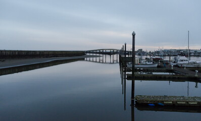 Quiet sunset in Westhaven Cove with perfect bridge reflections in water