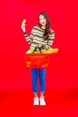 Portrait beautiful young asian woman with grocery basket from supermarket