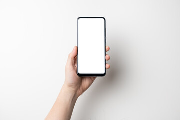 hand holding black mobile phone with white screen on white background - clipping path included