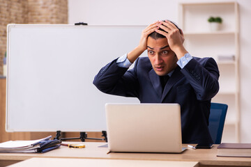 Young male employer in front of white board