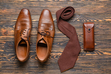 Stylish male accessories on wooden background