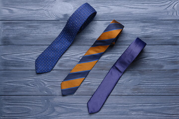 Stylish neckties on wooden background