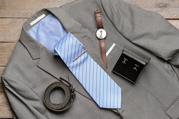 Stylish male clothes and accessories on wooden background