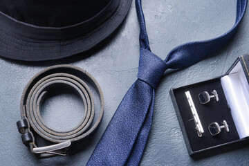 Stylish male accessories on dark background