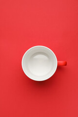 Empty cup on color background