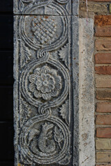 Moscufo - Abruzzo - Abbey of Santa Maria del Lago - Side detail of the portal with flat relief elements.
