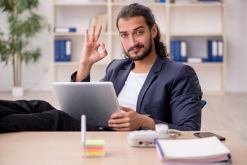 Young male employee working in the office