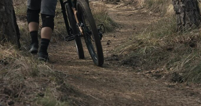 Mountain biker push mtb enduro bike uphill walk extreme sports trail