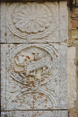 Moscufo - Abruzzo - Abbey of Santa Maria del Lago - Side detail of the portal with flat relief elements.