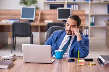 Young male employee working in the office