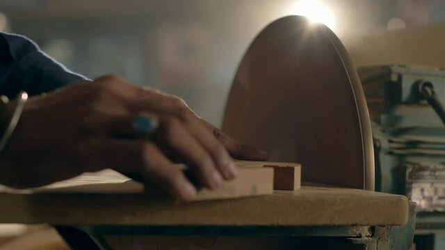 Closeup Of Furniture Maker Sanding Wood On A Electric Disc Sander Machine, Manufacturing Industry