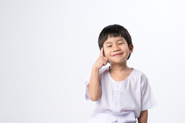 Asian boy in white dress with thinking expression