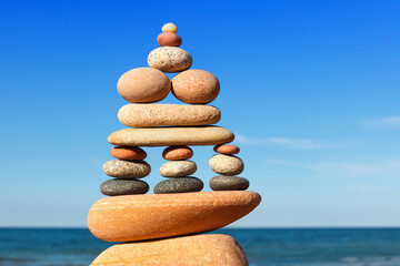 Rock zen pyramid of colorful pebbles on the background of the sea. Concept of Life balance