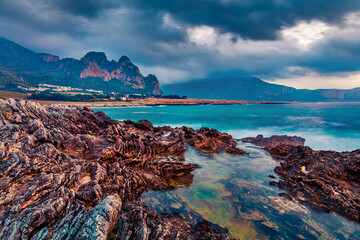Dramatic marine scenery. Fantastic summer sunrise on Sicily, Isolidda Beach, San Vito cape, Italy,...