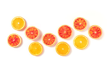 Blood oranges and regular oranges, top shot on a white background with a place for text. The concept of freshness